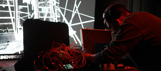 Artist playing modular synth live at a venue in Antwerp